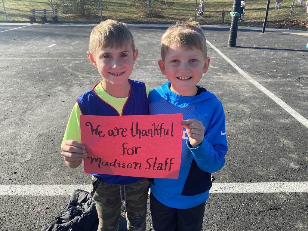 Students holding "Thankful" sign
