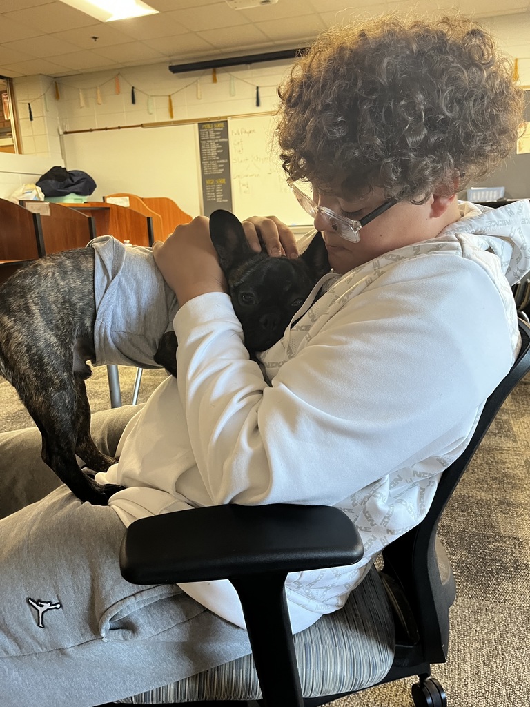 Student holds dog