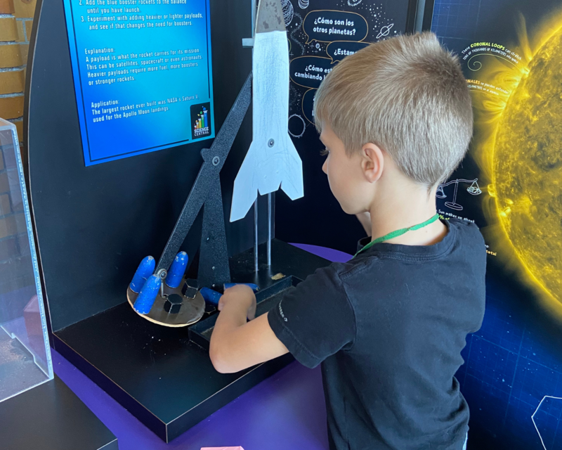 Xander Jervis exploring parts of a rocket